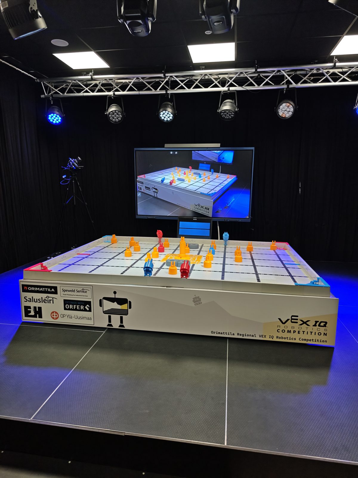 The VEX IQ Mix & Match competition field at Orimattila with sponsor logos and a live-stream screen